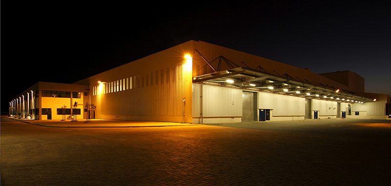 A business building at night light up with ample exterior security lights