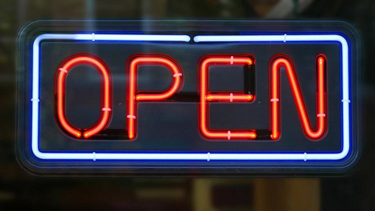 An open sign in the window of a business