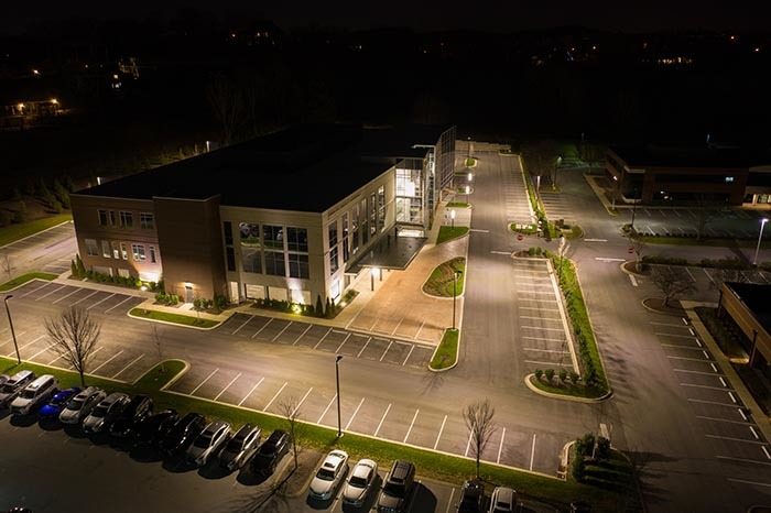 Aerial photo of a very well lit business parking lot at night