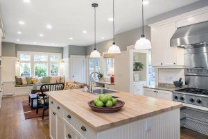 Bright kitchen with recessed lighting, pendant lighting over an island, and task lighting over stove top