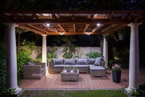Covered outdoor patio lit from above at night