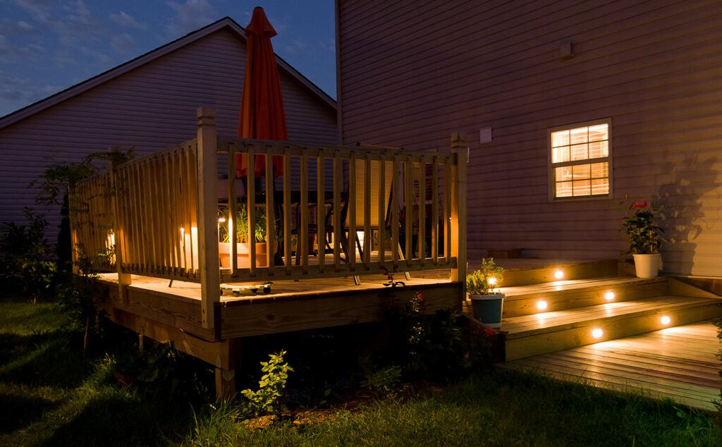 Back deck at twilight with beautifully illuminated lighted steps and perimeter lights