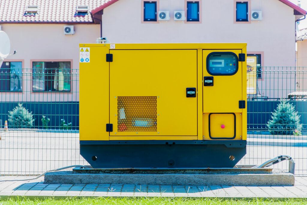 backup generator in a home's front yard next to the fence