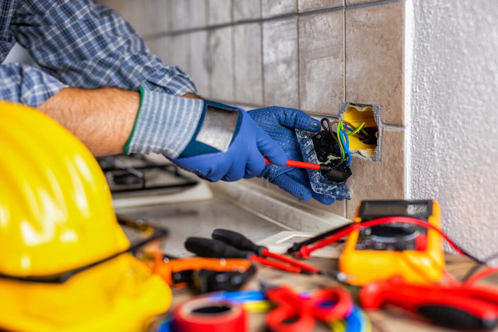 residential electrician fixes electrical system in a kitchen remodel