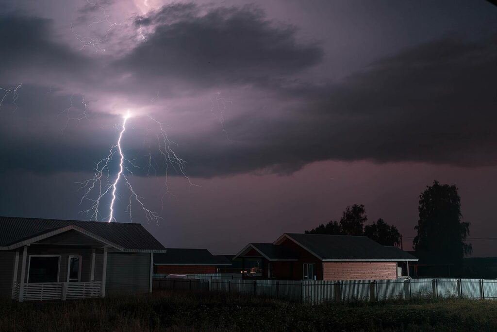Lightning over homes at night