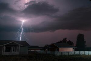 Lightning over homes at night