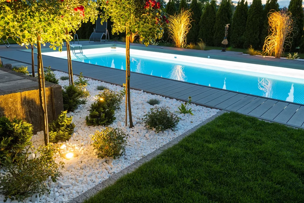 Beautiful backyard with an inground pool and stunning landscaping lighting design 