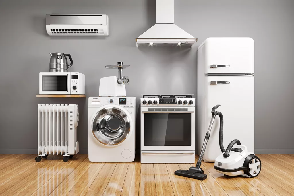 A collection of white energy efficient home appliances lined up against a gray wall.
