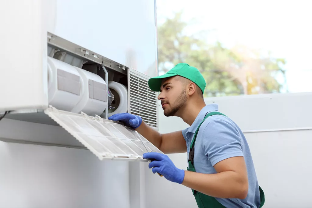 A professional technician repairs an HVAC system.