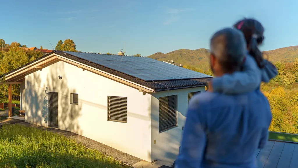 A homeowner looks at his house with solar panels from a distance, showing the concept of how much money solar panels can save homeowners in Sonoma County