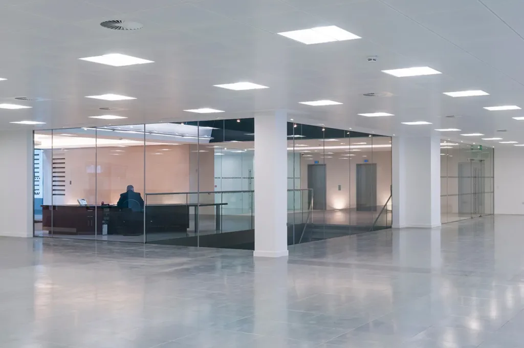 The interior of a large modern office space with bright LED lights, showing the concept of commercial lighting repair